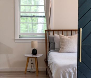 A serene and cozy bedroom interior featuring a comfortable bed and soft lighting, perfect for relaxation.
